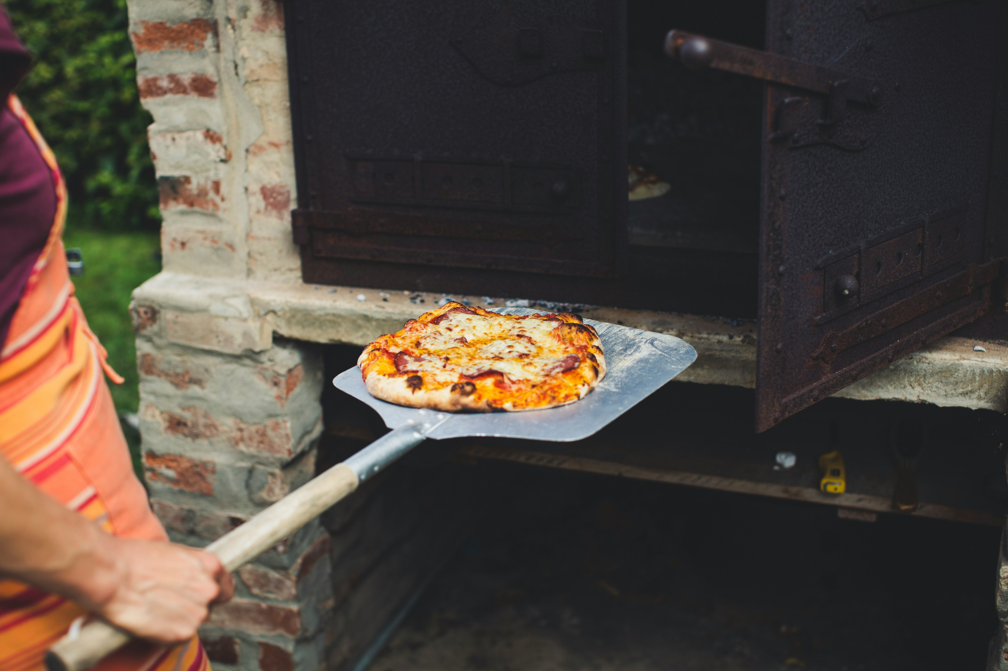 person holding white and brown pizza